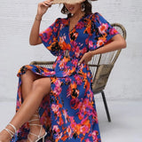Women's tropical neon floral high-low wrap dress with flutter sleeves, V-neckline, and belted waist – lightweight chiffon vacation maxi.
