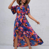 Women's tropical neon floral high-low wrap dress with flutter sleeves, V-neckline, and belted waist – lightweight chiffon vacation maxi.