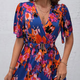Women's tropical neon floral high-low wrap dress with flutter sleeves, V-neckline, and belted waist – lightweight chiffon vacation maxi.