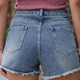 Women's high-waisted denim shorts with faux pearl embellishments and frayed hem – trendy summer jean shorts for casual and chic outfits.