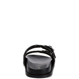 Women’s nubuck faux leather slide sandals with silver buckle straps, metal eyelet embellishments, and flat black soles in olive green and black color options.