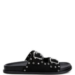 Women’s nubuck faux leather slide sandals with silver buckle straps, metal eyelet embellishments, and flat black soles in olive green and black color options.
