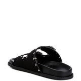 Women’s nubuck faux leather slide sandals with silver buckle straps, metal eyelet embellishments, and flat black soles in olive green and black color options.