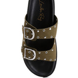 Women’s nubuck faux leather slide sandals with silver buckle straps, metal eyelet embellishments, and flat black soles in olive green and black color options.
