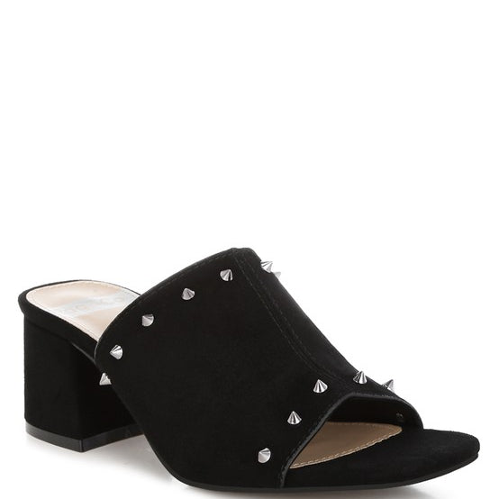 Black microsuede open-toe mule with silver cone studs and mid block heel, shown from multiple angles against white background.