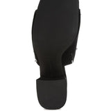 Black microsuede open-toe mule with silver cone studs and mid block heel, shown from multiple angles against white background.