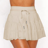 Women's sand beige ruffle tennis skort with high-waist fit, adjustable drawstring, and built-in stretch shorts for workouts.