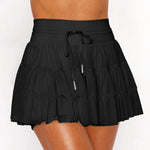 Women's black high-waist ruffle athletic skort with triple mesh tiers, drawstring waistband, and hidden shorts.