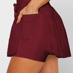 Women's wine red ruffle athletic skort with high-waist drawstring waistband and built-in shorts – moisture-wicking tennis skirt.