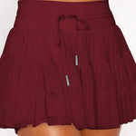 Women's wine red ruffle athletic skort with high-waist drawstring waistband and built-in shorts – moisture-wicking tennis skirt.