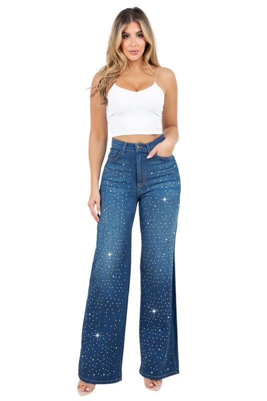 Woman modeling high-rise wide-leg blue “Starlight Rhinestone” jeans, denim sprinkled with sparkling crystal studs and star-dot back pockets.