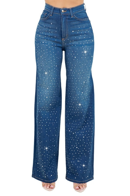 Woman modeling high-rise wide-leg blue “Starlight Rhinestone” jeans, denim sprinkled with sparkling crystal studs and star-dot back pockets.