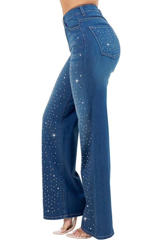 Woman modeling high-rise wide-leg blue “Starlight Rhinestone” jeans, denim sprinkled with sparkling crystal studs and star-dot back pockets.