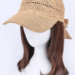 Women’s woven straw baseball cap with curved visor, breathable crochet crown, and adjustable tan bow-back tie, shown from multiple angles.