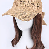 Women’s woven straw baseball cap with curved visor, breathable crochet crown, and adjustable tan bow-back tie, shown from multiple angles.