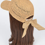 Women’s woven straw baseball cap with curved visor, breathable crochet crown, and adjustable tan bow-back tie, shown from multiple angles.