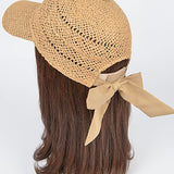 Women’s woven straw baseball cap with curved visor, breathable crochet crown, and adjustable tan bow-back tie, shown from multiple angles.