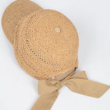 Women’s woven straw baseball cap with curved visor, breathable crochet crown, and adjustable tan bow-back tie, shown from multiple angles.