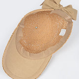 Women’s woven straw baseball cap with curved visor, breathable crochet crown, and adjustable tan bow-back tie, shown from multiple angles.