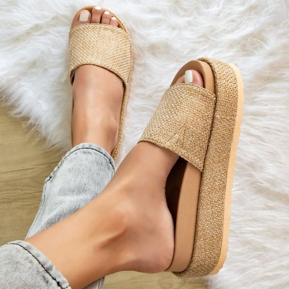 Woman wearing woven raffia flatform slide sandals in neutral beige, showcasing chunky espadrille-style platform perfect for summer casual outfits.