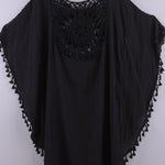 Women’s boho crochet-medallion beach cover-up poncho with tassel trim in lightweight cotton gauze, shown in Black.