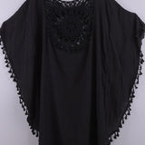 Women’s boho crochet-medallion beach cover-up poncho with tassel trim in lightweight cotton gauze, shown in Black.