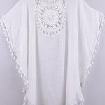 Women’s boho crochet-medallion beach cover-up poncho with tassel trim in lightweight cotton gauze, shown in White.