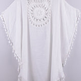 Women’s boho crochet-medallion beach cover-up poncho with tassel trim in lightweight cotton gauze, shown in White.
