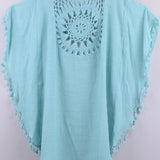 Women’s boho crochet-medallion beach cover-up poncho with tassel trim in lightweight cotton gauze, shown in Light Blue.