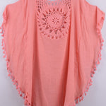 Women’s boho crochet-medallion beach cover-up poncho with tassel trim in lightweight cotton gauze, shown in Coral.