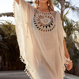 Women’s boho crochet-medallion beach cover-up poncho with tassel trim in lightweight cotton gauze, shown in Cream.