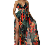 Woman wearing a vibrant tropical floral cut-out halter maxi dress with gold chain belt and thigh-high slit.
