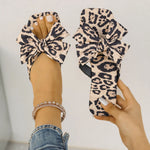 Women's leopard print bow slide sandals with square toe – stylish slip-on flat summer shoes for casual wear, featuring oversized knot bow detail.