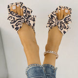 Women's leopard print bow slide sandals with square toe – stylish slip-on flat summer shoes for casual wear, featuring oversized knot bow detail.