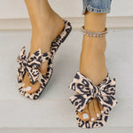 Women's leopard print bow slide sandals with square toe – stylish slip-on flat summer shoes for casual wear, featuring oversized knot bow detail.