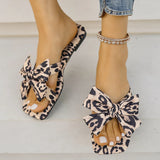 Women's leopard print bow slide sandals with square toe – stylish slip-on flat summer shoes for casual wear, featuring oversized knot bow detail.