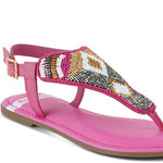 Pink, black and beige flat sandals with Aztec-style hand-beaded T-strap uppers, adjustable ankle buckle and cushioned footbed, boho summer women’s footwear.