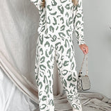 Woman standing and smiling in full-length view of sage and white animal print loungewear set, styled with sneakers and a mini handbag.