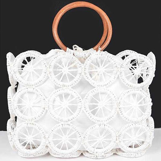 White raffia circle-grid handbag with contrasting wooden handles and secure drawstring pouch.