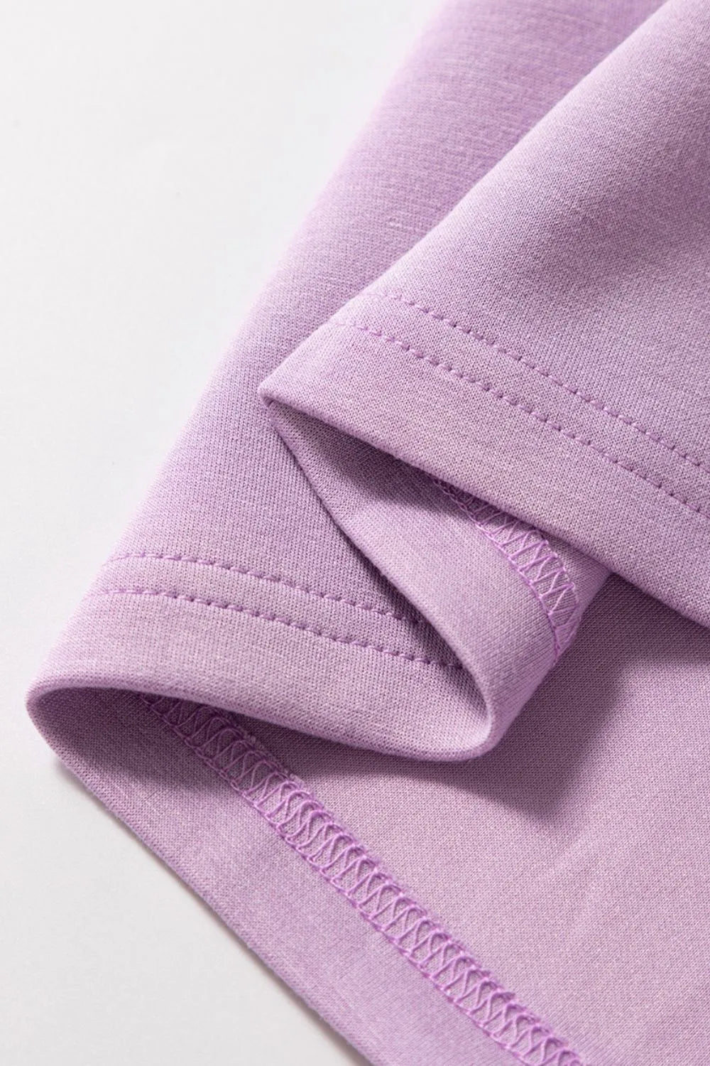 Short Sleeve Zipper Collared Elastic High Waist Romper in pink up close of the hem
