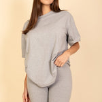 Women's oversized two-piece lounge set featuring a relaxed fit short-sleeve tee and high-waisted biker shorts, available in multiple vibrant colors. Perfect for casual wear, workouts, or athleisure style.