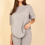 Women's oversized two-piece lounge set featuring a relaxed fit short-sleeve tee and high-waisted biker shorts, available in multiple vibrant colors. Perfect for casual wear, workouts, or athleisure style.