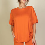 Women's oversized two-piece lounge set featuring a relaxed fit short-sleeve tee and high-waisted biker shorts, available in multiple vibrant colors. Perfect for casual wear, workouts, or athleisure style.