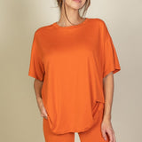 Women's oversized two-piece lounge set featuring a relaxed fit short-sleeve tee and high-waisted biker shorts, available in multiple vibrant colors. Perfect for casual wear, workouts, or athleisure style.