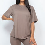 Women's oversized two-piece lounge set featuring a relaxed fit short-sleeve tee and high-waisted biker shorts, available in multiple vibrant colors. Perfect for casual wear, workouts, or athleisure style.