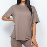 Women's oversized two-piece lounge set featuring a relaxed fit short-sleeve tee and high-waisted biker shorts, available in multiple vibrant colors. Perfect for casual wear, workouts, or athleisure style.
