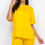 Women's oversized two-piece lounge set featuring a relaxed fit short-sleeve tee and high-waisted biker shorts, available in multiple vibrant colors. Perfect for casual wear, workouts, or athleisure style.
