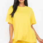 Women's oversized two-piece lounge set featuring a relaxed fit short-sleeve tee and high-waisted biker shorts, available in multiple vibrant colors. Perfect for casual wear, workouts, or athleisure style.