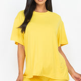 Women's oversized two-piece lounge set featuring a relaxed fit short-sleeve tee and high-waisted biker shorts, available in multiple vibrant colors. Perfect for casual wear, workouts, or athleisure style.
