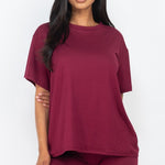 Women's oversized two-piece lounge set featuring a relaxed fit short-sleeve tee and high-waisted biker shorts, available in multiple vibrant colors. Perfect for casual wear, workouts, or athleisure style.